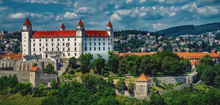 Bratislava Castle with its white façade and red roofs seen from a distance