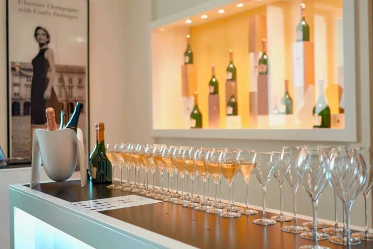 Row of champagne glasses half filled for a tasting at Taittinger Champagne House in Reims, France.