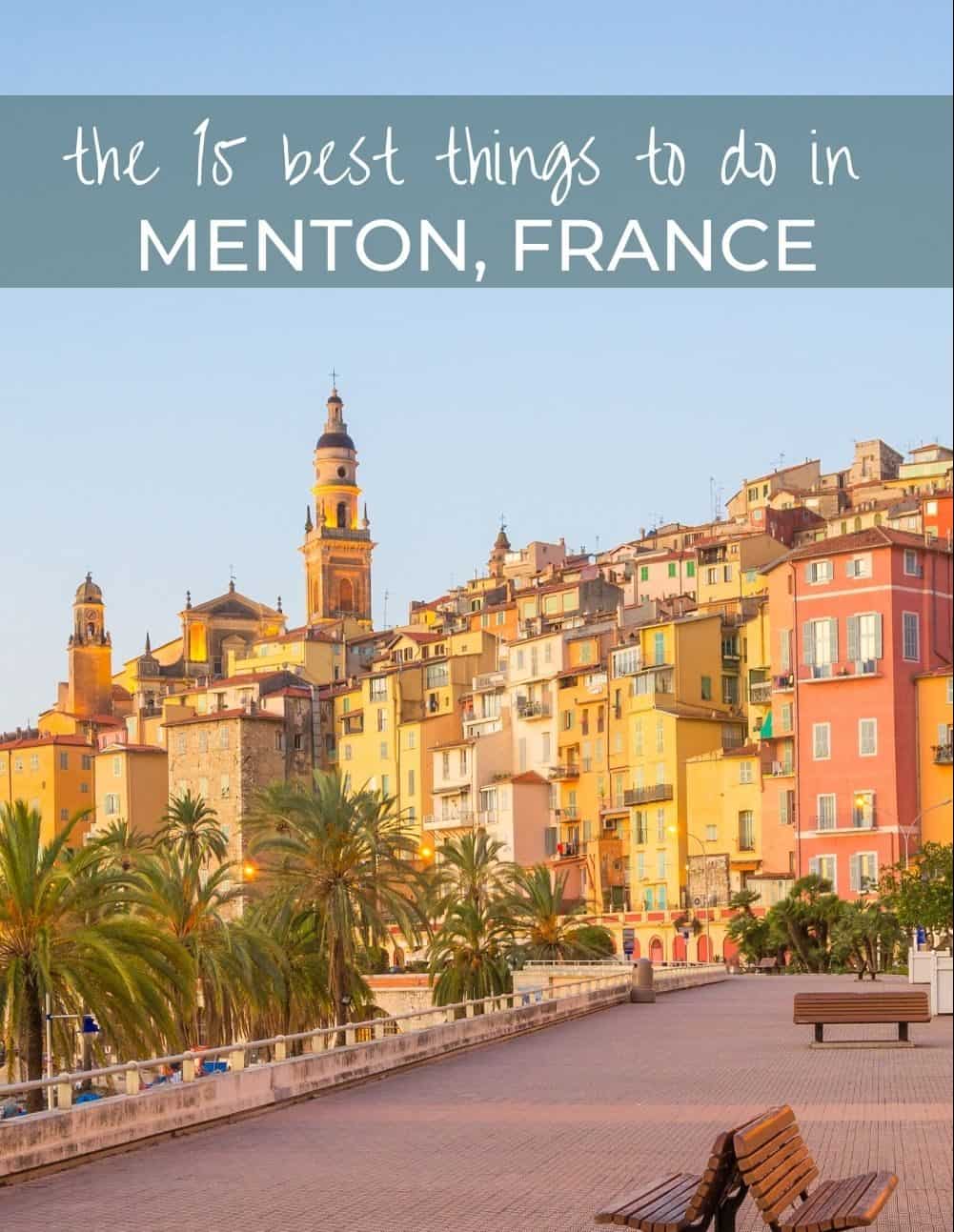 Promenade along the water with colorful buildings and palm trees in Menton, France.